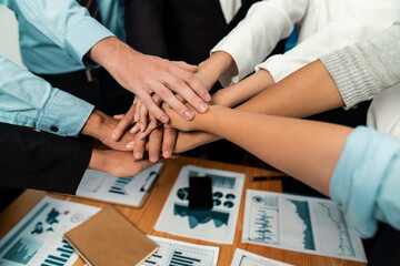 Multiracial business people make synergy hand stack together in meeting room as cooperation or team...