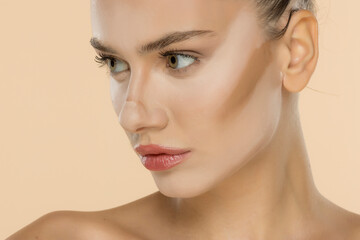 Side profile showcasing professional makeup application with seamless foundation and contour...