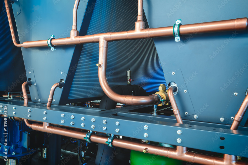 Poster pipe is made of copper and is curved. the pipe is attached to the wall. the pipe is curved in such a