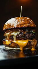 Delicious hamburger with melted cheddar cheese and caramelized onions dripping over the bun
