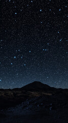 starry night sky over a mountainous landscape under clear conditions