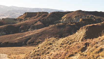 Sand clay cliffs in sunrise light in Bannockburn Sluicings New Zealand stunning landscape