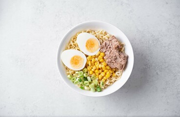 Ramen noodles with pollock liver, corn and scallions in a bowl