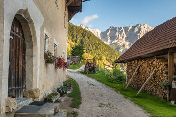 Traditional old stone house with Kamnik-Savinja Alps in the background in Slovenia