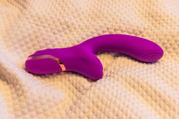 Pink vibrator rabbit on a bed