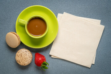 cup of coffee with French macarons and strawberry
