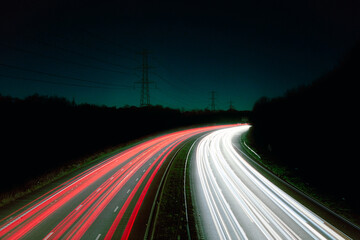 Light trails from moving traffic on a high speed road or motorway, freeway, highway - theme or suggestion of speed, movement, travelling, motion, information transfer