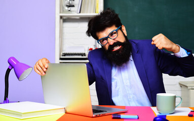 Angry office worker having problem with technology. Enraged bearded businessman or male teacher...