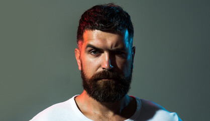 Man portrait. Serious confident man with beard and mustache in casual clothes. Closeup portrait of brutal bearded man. Handsome bearded man with stylish hairstyle. Fashion male model in white t-shirt.