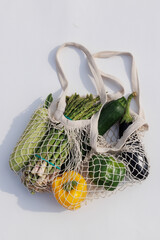 Fresh assorted vegetables in an eco-friendly woven bag, ready for a healthy and sustainable meal