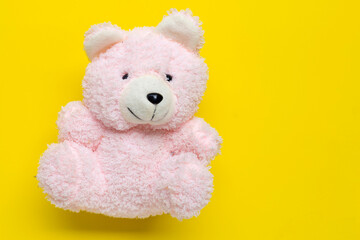Teddy bear on yellow backgrond.