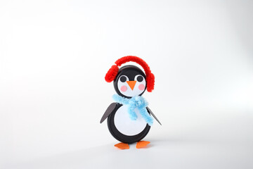 DIY penguin and snowman crafts made from plastic bottle caps with pipe cleaner accessories on white background. Winter and Christmas craft for eco-friendly brands, holiday kids entertainment,