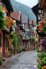 Fototapeta premium Village street view. Old style houses with flowers. Wet stones on the street. Beautiful landscape. Colorful plants near buildings.