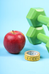 Healthy Lifestyle Concept with Apple, Dumbbells, and Measuring Tape