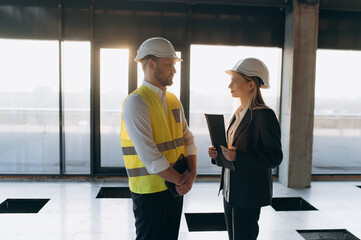 Engineers Discussing Project Details in Modern Construction Site Environment. architect or engineer and designer communicating at construction site