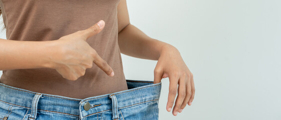 Women showing results of diet. Beautiful shape. female have a reduced waist size after under going a weight loss corse. can not wear jeans due to weight loss. balance, control, routines, exercise.