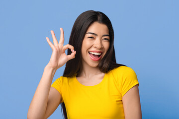 Everything is Great. Joyful Asian Woman Showing Ok Sign, Isolated On Purple Background With Copy...