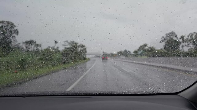 driving on a rainy day, the wiper sweeps away the rainwater on the windshield of the car