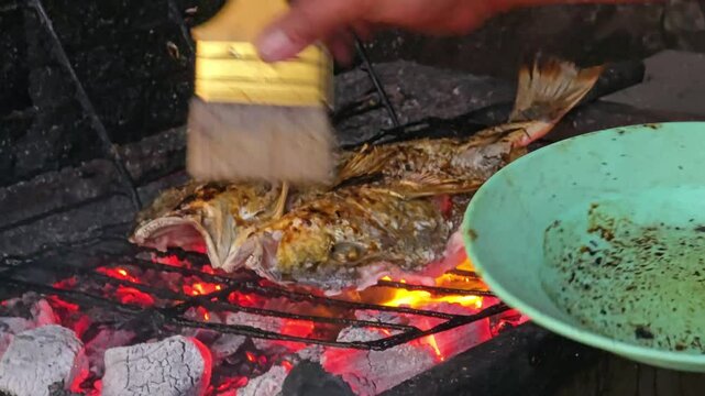 grilled fish, the process of cooking fish on a grill with charcoal flames