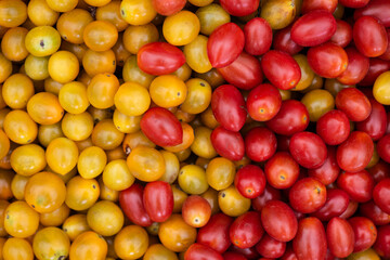 Yellow Pear and red tomato fruits on natural background.