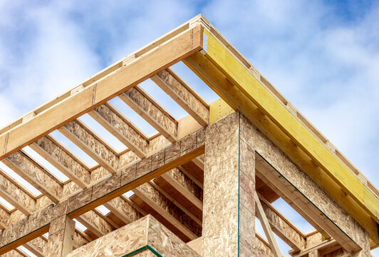 Roof corner construction detail showing engineered wood joists and Laminated Veneer Lumber (LVL) headers  with oriented strand board, Chip board wall sheathing
