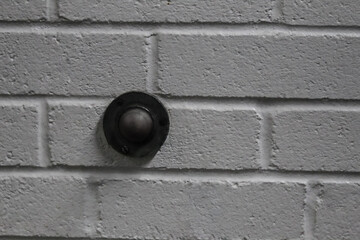abstract old door stop on a white painted concrete block wall urban background