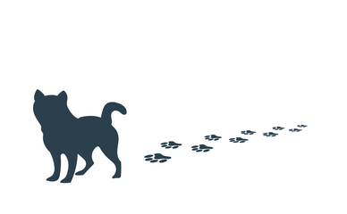 足跡をつけながら歩く犬のシルエット