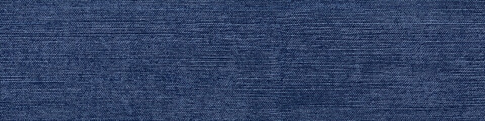 Seamless textured denim plain fabric in a deep blue color, showcasing the weave and pattern typical of denim material.