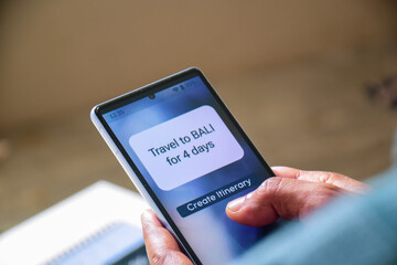 Man making travel itinerary for 4 day Bali visit using mobile applications. Hassle-free time saving way to make vacation plans concept. Selective focus, artificial intelligence. 