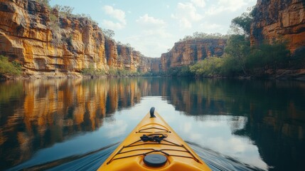 Fototapeta premium A yellow kayak navigates through a canyons scenic waterway
