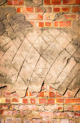 Brick wall covered with diamond pattern carved in cement.