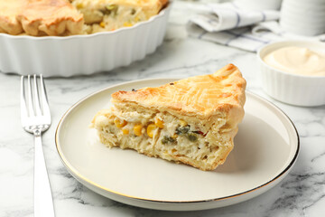 Piece of tasty homemade pie with chicken and vegetables on white marble table, closeup