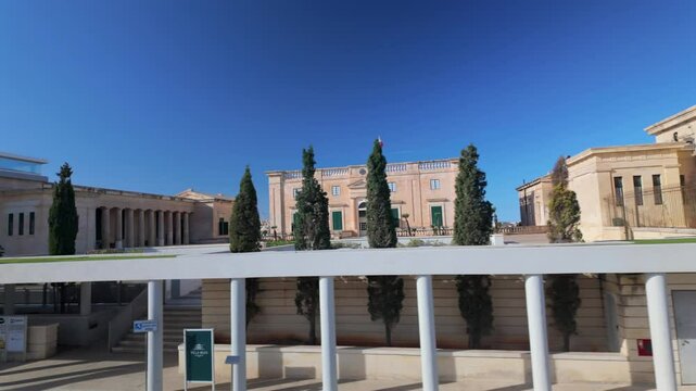 Villa Bighi, a historic neoclassical building in Kalkara, Malta, originally a naval hospital, now houses the Esplora Interactive Science Centre. The scene features grand limestone architecture .