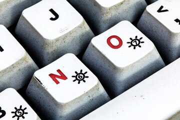 Keyboard button with NO written in red color. Close up macro photo of worn vintage keyboard