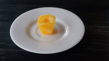 Rock sugar in a cup on a wooden table