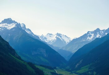 Majestic mountain range, snow-capped peaks, lush green valley, rocky, wilderness