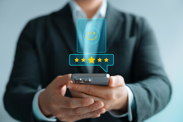 Satisfaction survey, customers use smartphones to rate their experience with five stars, online application services with happy smiley icons, feedback, service quality business reputation rankings.