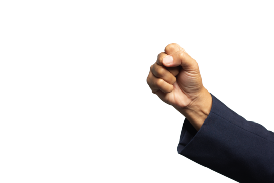 Close-up of a clenched fist in a business suit against a dark background, symbolizing power, strength, and determination.