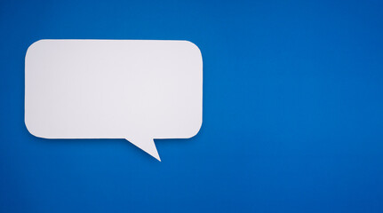 Blank speech bubble cutout placed on a blue background.