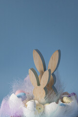 Creative handmade Easter table decoration with egg shells bunny and eggs instruction on pastel blue background copy space. Greeting card idea Easter home tradition Seasonal sustainable recycled decor