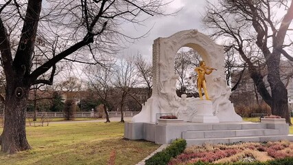 Golden statue of Johann Strauss playing violin in Stadtpark Vienna Austria