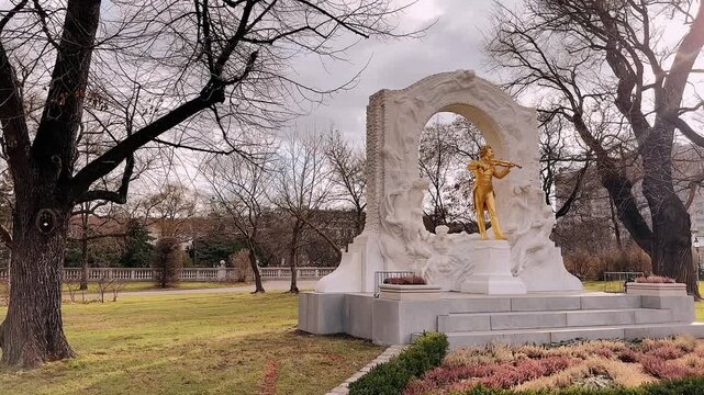 Golden statue of Johann Strauss playing violin in Stadtpark Vienna Austria