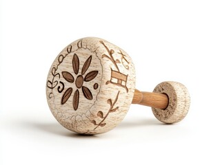 Beige Wooden Rattle Toy with Engraved Floral Pattern on White Background