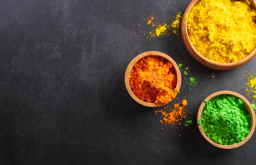 Happy Holi decoration, the indian festival.Top view of colorful holi powder on dark background.