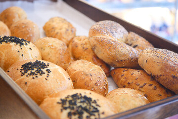 Freshly baked bread rolls displayed at a market stall in the morning
