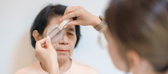 Senior Woman during eye protecting by shield after eye surgery. Eye disease, Cataract,  Glaucoma, Age Related Macular Degeneration, Diabetic Retinopathy, Vitreous, Lasik, World Glaucoma day and health
