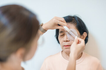 Fototapeta premium Senior Woman during eye protecting by shield after eye surgery. Eye disease, Cataract, Glaucoma, Age Related Macular Degeneration, Diabetic Retinopathy, Vitreous, Lasik, World Glaucoma day and health