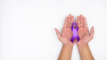 Man hands holding purple ribbon symbol of cancer awareness isolated on white background