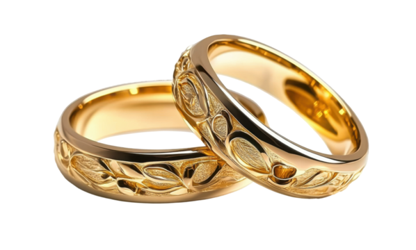 gold wedding rings with engraved floral design on white background