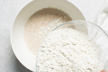 overhead view of All purpose flour in a bowl, top view of baking flour in a glass bowl